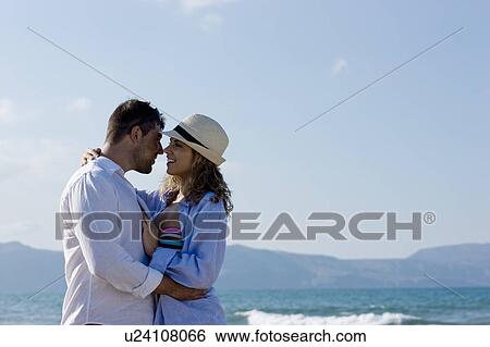 couple on the beach hugging View Large Photo Image Stock Photograph - couple on the beach hugging. Fotosearch