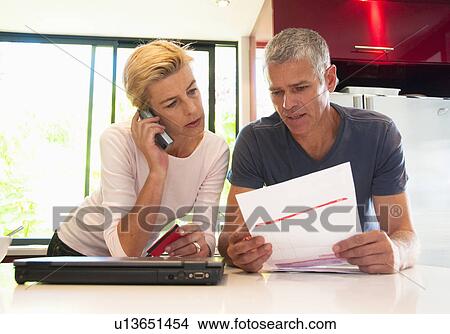 Couple pay bills View Large Photo Image Picture - Couple pay bills. Fotosearch