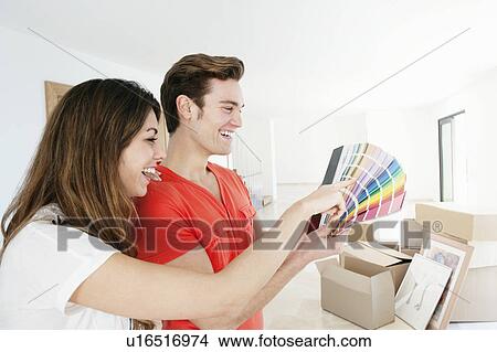 Couple picking out paint in new home View Large Photo Image Picture - Couple picking out paint in new home. Fotosearch