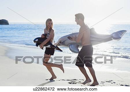 Couple playing with toys on beach View Large Photo Image Stock Image - Couple playing with toys on beach. Fotosearch