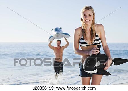 Couple playing with toys on beach View Large Photo Image Stock Photo - Couple playing with toys on beach. Fotosearch