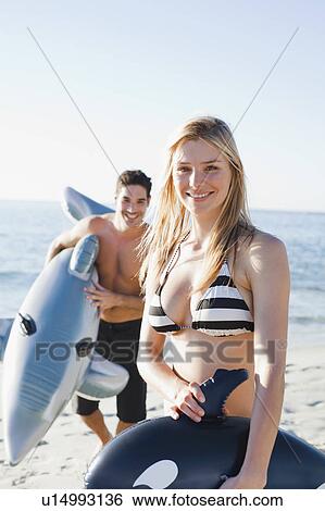 Couple playing with toys on beach View Large Photo Image Stock Photograph - Couple playing with toys on beach. Fotosearch
