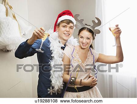 Couple raising champagne glasses View Large Photo Image Stock Photo - Couple raising champagne glasses. Fotosearch