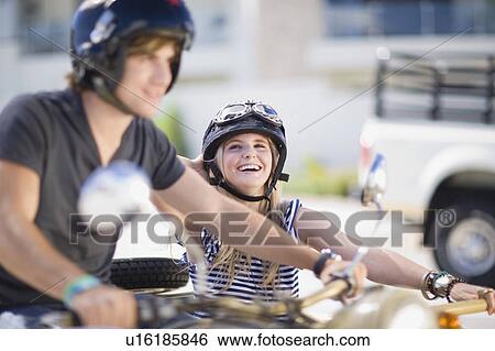 Couple riding a motorbike View Large Photo Image Stock Photograph - Couple riding a motorbike. Fotosearch