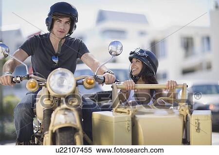 Couple riding a motorbike View Large Photo Image Stock Photography - Couple riding a motorbike. Fotosearch