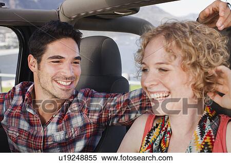 Stock Photography - Couple riding in jeep together. Fotosearch