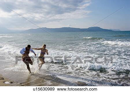 couple running on the beach View Large Photo Image Stock Photo - couple running on the beach. Fotosearch