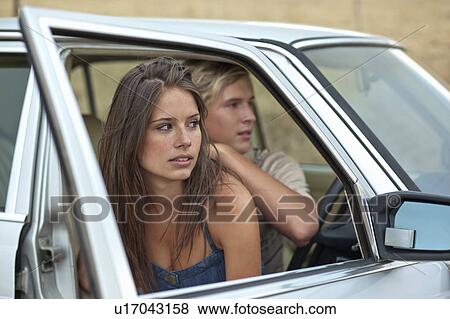 Couple sitting in car View Large Photo Image Stock Photo - Couple sitting in car. Fotosearch