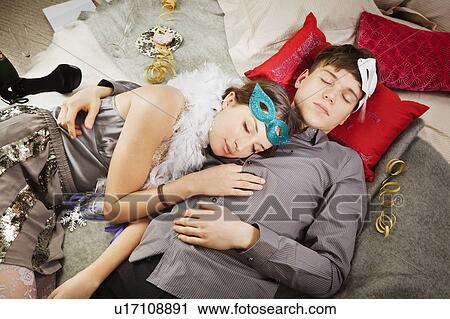 Stock Image - Couple sleeping after party. Fotosearch