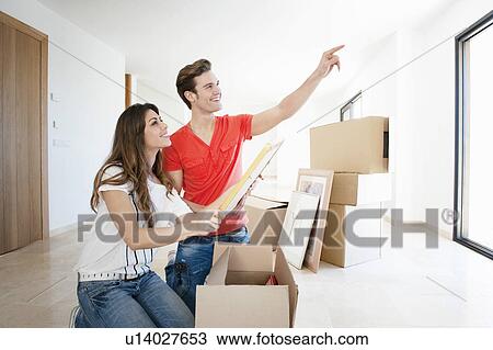 Couple unpacking box in new home View Large Photo Image Stock Image - Couple unpacking box in new home. Fotosearch