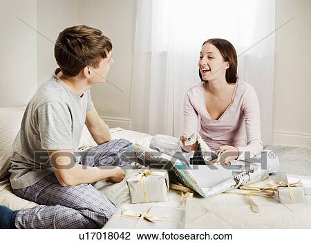 Stock Image - Couple unpacking presents. Fotosearch