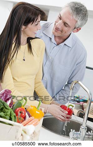 Couple washing fresh vegetables View Large Photo Image Stock Image - Couple washing fresh vegetables. Fotosearch