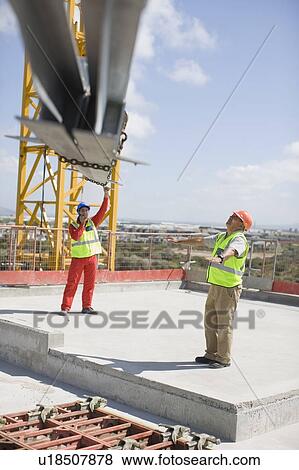 Crane and workers on construction site View Large Photo Image Stock Photo - Crane and workers on construction site. Fotosearch