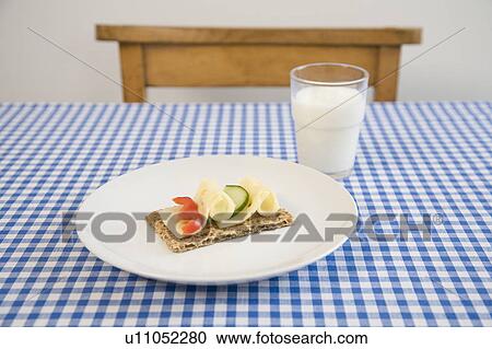 Stock Image - Crisp bread with cheese, glass of milk. Fotosearch