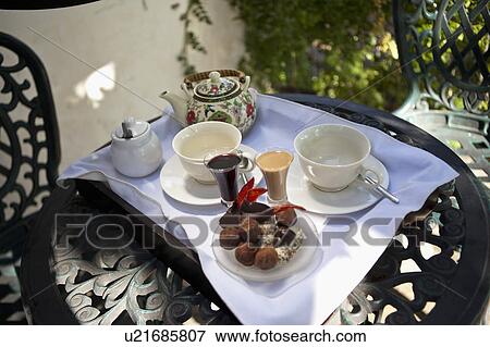 Stock Photo - Cups and tea and Chocolate on a table. Fotosearch