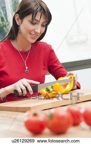 Cutting yellow pepper at kitchen View Large Photo Image Stock Photo - Cutting yellow pepper at kitchen. Fotosearch