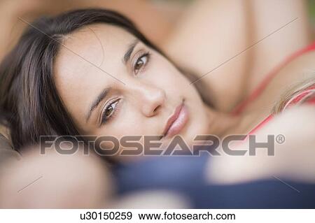 Stock Photo - darkhaired woman sunbathing. Fotosearch