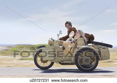 Disguised couple on motorbike View Large Photo Image Stock Image - Disguised couple on motorbike. Fotosearch