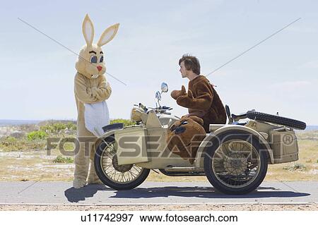 Disguised couple on motorbike View Large Photo Image Stock Photo - Disguised couple on motorbike. Fotosearch