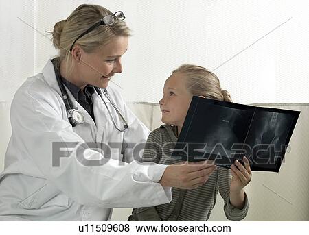 Doctor and girl with x-ray View Large Photo Image Stock Photo - Doctor and girl with x-ray. Fotosearch