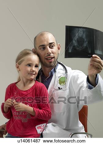 Stock Photo - Doctor and girl with x-ray. Fotosearch