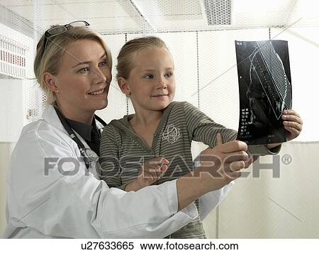 Stock Photography - Doctor and girl with x-ray. Fotosearch