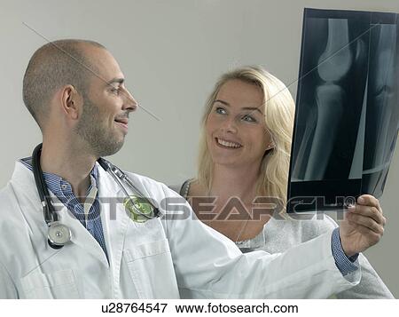 Doctor and woman with x-ray View Large Photo Image Stock Photo - Doctor and woman with x-ray. Fotosearch