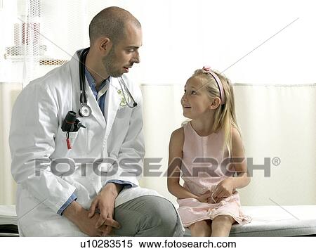 Doctor consulting girl View Large Photo Image Stock Photography - Doctor consulting girl. Fotosearch