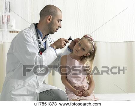 Stock Image - Doctor examining girl. Fotosearch