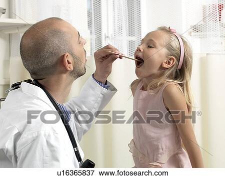 Doctor examining girl View Large Photo Image Stock Photo - Doctor examining girl. Fotosearch