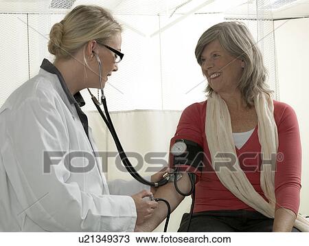 Doctor examining mature woman View Large Photo Image Stock Image - Doctor examining mature woman. Fotosearch