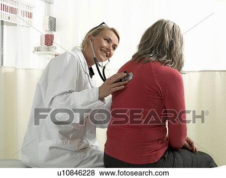 Stock Photo - Doctor examining mature woman. Fotosearch