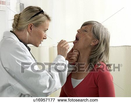 Stock Photo - Doctor examining mature woman. Fotosearch