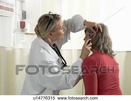 Stock Photography - Doctor examining mature woman. Fotosearch