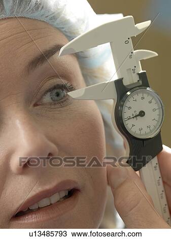 Stock Image - Doctor examining patient. Fotosearch