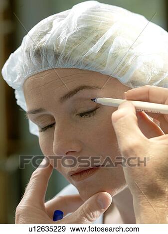 Doctor preparing patient for surgery View Large Photo Image Stock Photo - Doctor preparing patient for surgery. Fotosearch