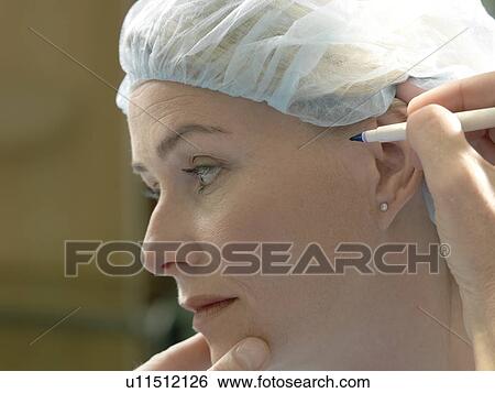 Doctor preparing patient for surgery View Large Photo Image Stock Photograph - Doctor preparing patient for surgery. Fotosearch