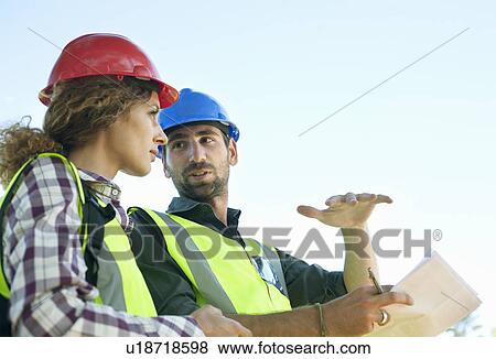 Stock Photo - Engineer and architect having meeting. Fotosearch