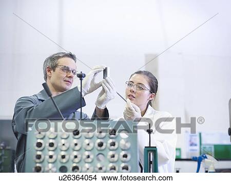 Engineer and scientist inspect part View Large Photo Image Picture - Engineer and scientist inspect part. Fotosearch