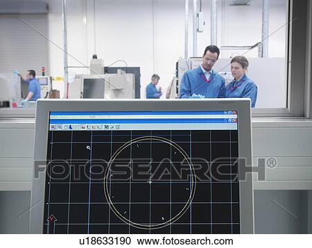 Stock Image - Engineers and CAD drawing on monitor. Fotosearch