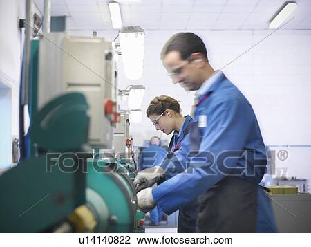Engineers grinding in factory View Large Photo Image Stock Image - Engineers grinding in factory. Fotosearch