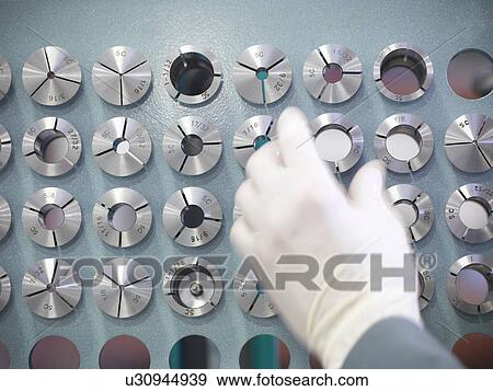 Stock Photo - Engineer's hand with parts. Fotosearch