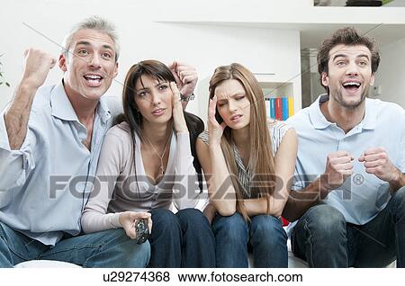 Stock Photo - Excitement and boredom at TV. Fotosearch