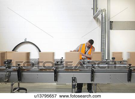 Factory worker checking boxes in plant View Large Photo Image Stock Photo - Factory worker checking boxes in plant. Fotosearch