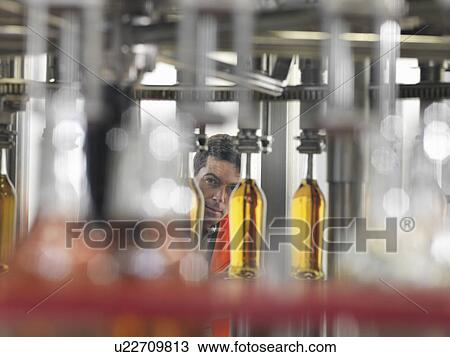 Factory worker in bottling plant View Large Photo Image Stock Image - Factory worker in bottling plant. Fotosearch