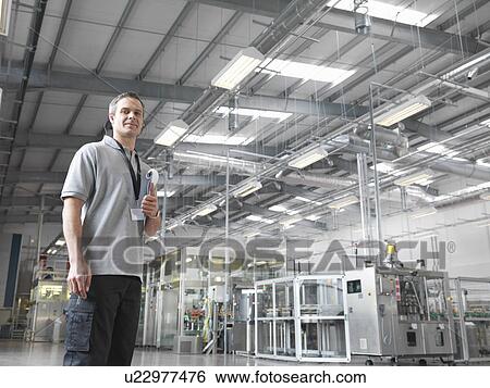 Factory worker in bottling plant View Large Photo Image Stock Photograph - Factory worker in bottling plant. Fotosearch