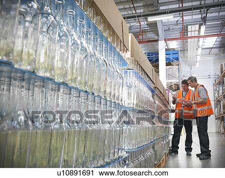 Factory workers examining bottles View Large Photo Image Stock Image - Factory workers examining bottles. Fotosearch