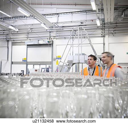 Factory workers examining bottles View Large Photo Image Stock Photo - Factory workers examining bottles. Fotosearch