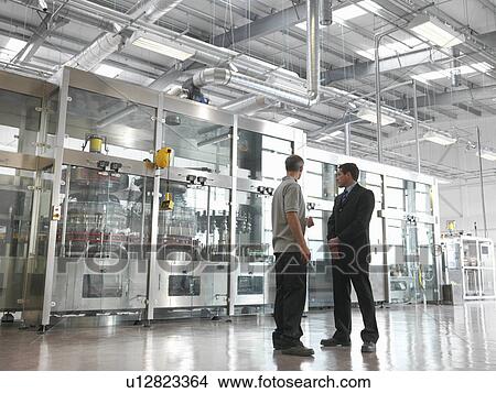 Factory workers in bottling plant View Large Photo Image Picture - Factory workers in bottling plant. Fotosearch