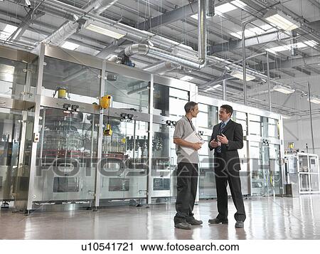 Factory workers in bottling plant View Large Photo Image Stock Image - Factory workers in bottling plant. Fotosearch